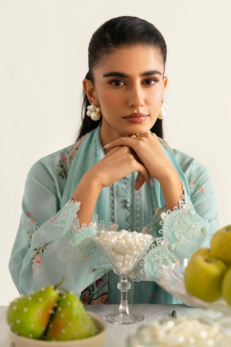 Model wearing Qalamkar Qprints '25 PQ - 08 Rena dress in pastel mint green with delicate floral embroidery. Shop Pakistani clothes online in the UK now.