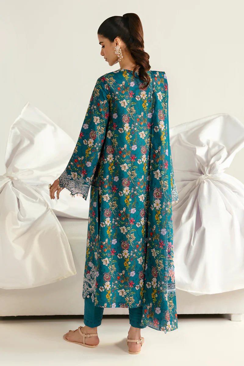 Model wearing Qalamkar Qprints '25 PQ - 10 Faha dress in teal with vibrant floral prints and lace detailing. Shop Pakistani clothes online in the UK now.