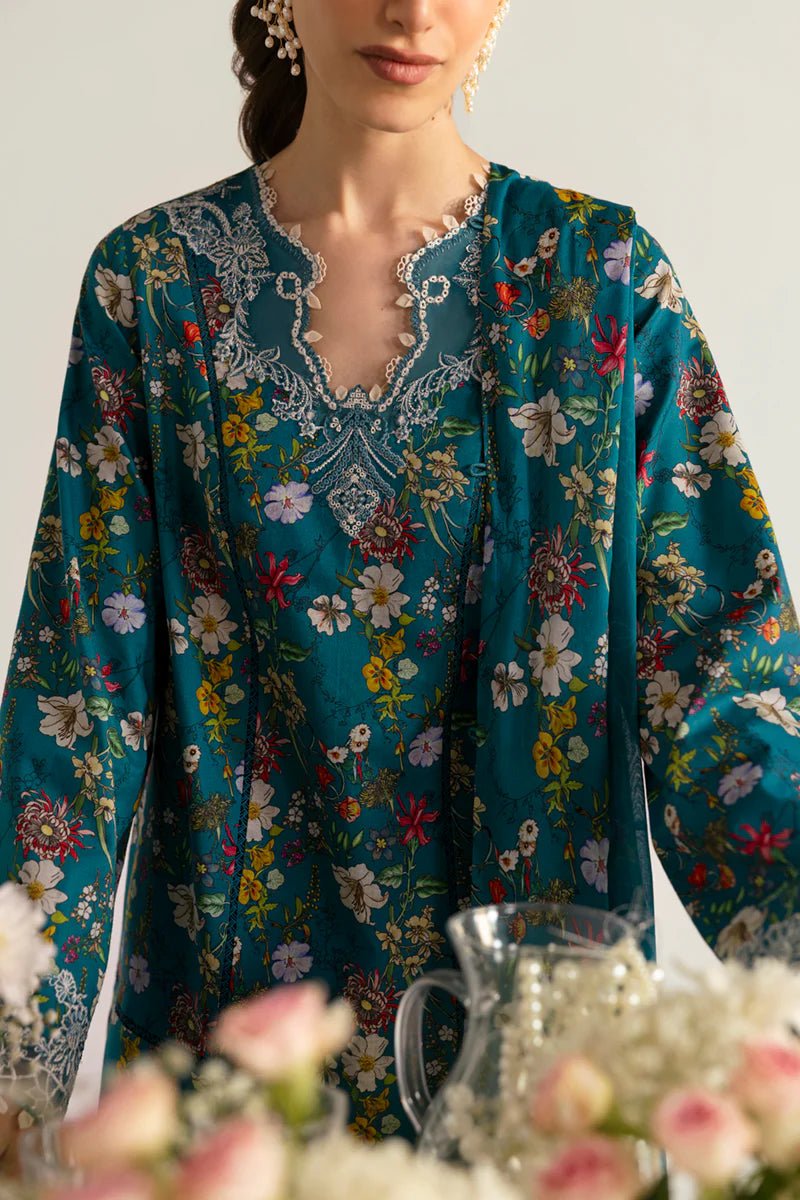 Model wearing Qalamkar Qprints '25 PQ - 10 Faha dress in teal with vibrant floral prints and lace detailing. Shop Pakistani clothes online in the UK now.