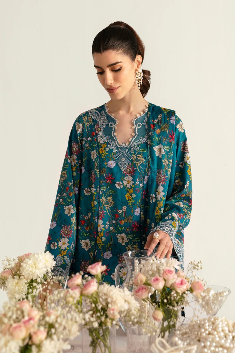 Model wearing Qalamkar Qprints '25 PQ - 10 Faha dress in teal with vibrant floral prints and lace detailing. Shop Pakistani clothes online in the UK now.