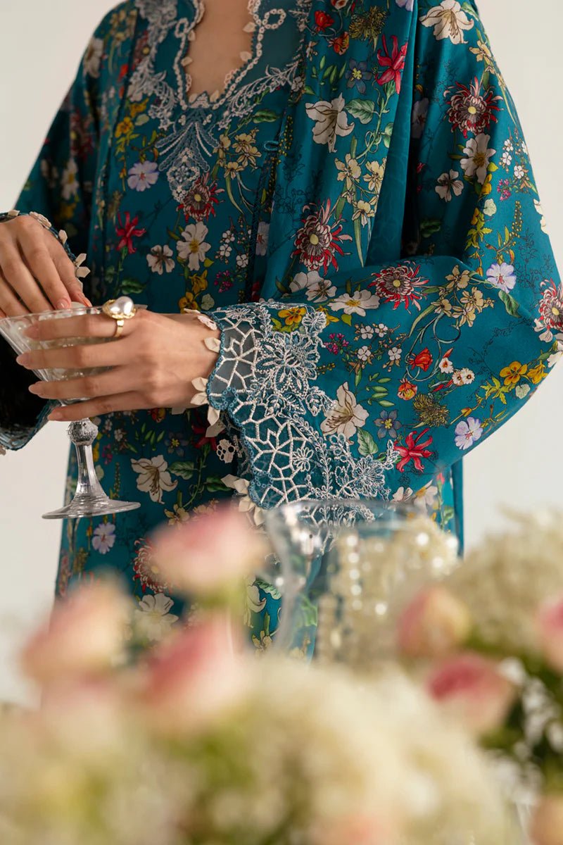 Model wearing Qalamkar Qprints '25 PQ - 10 Faha dress in teal with vibrant floral prints and lace detailing. Shop Pakistani clothes online in the UK now.