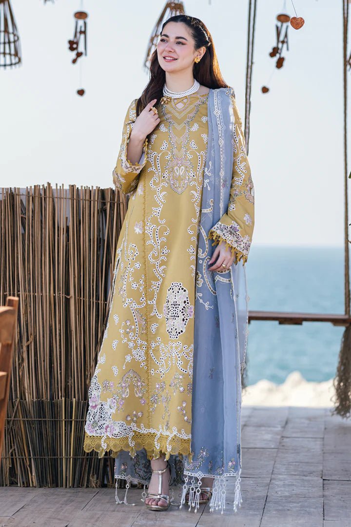 Model wearing mustard yellow FP - 03 SELMA dress with white and pastel embroidery, from Qalamkar, showcasing Pakistani lawn suits online in the UK.