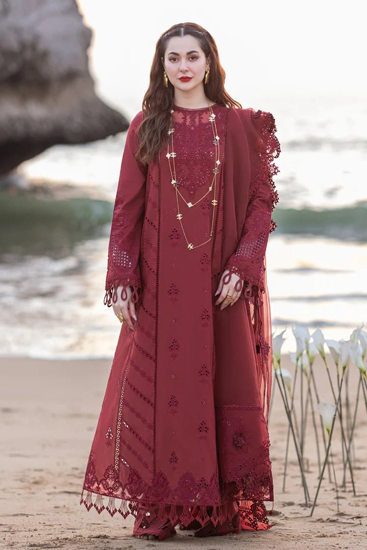 Model wearing maroon FP - 07 AISHA dress from Qalamkar by the beach. Highlighting Pakistani clothes online in UK, lawn suits, and luxury lawn 2024.