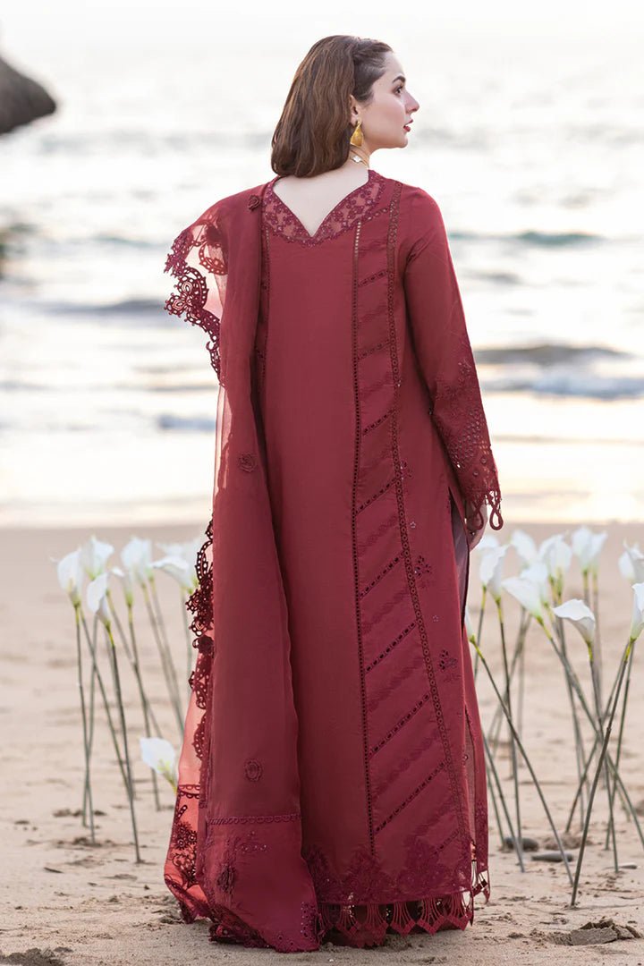 Model wearing maroon FP - 07 AISHA dress from Qalamkar by the beach. Highlighting Pakistani clothes online in UK, lawn suits, and luxury lawn 2024.