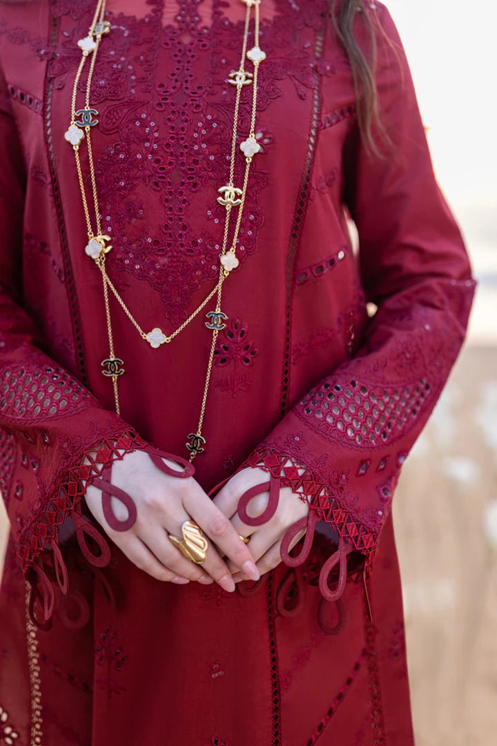 Model wearing maroon FP - 07 AISHA dress from Qalamkar by the beach. Highlighting Pakistani clothes online in UK, lawn suits, and luxury lawn 2024.