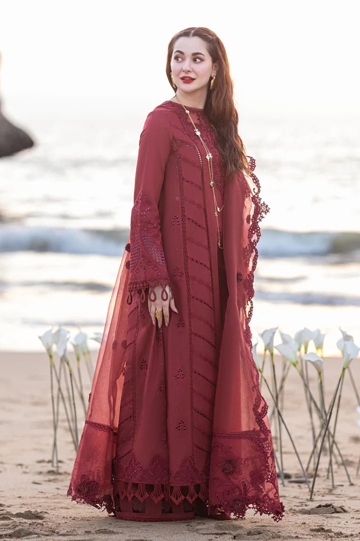 Model wearing maroon FP - 07 AISHA dress from Qalamkar by the beach. Highlighting Pakistani clothes online in UK, lawn suits, and luxury lawn 2024.