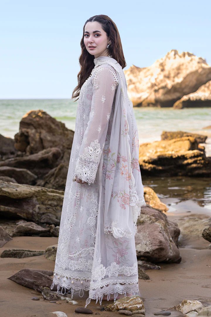 Model wearing Qalamkar's FP - 11 EMIRA dress in soft lavender with intricate embroidery, available in the UK. Ideal for luxury lawn suits and Pakistani clothes online.