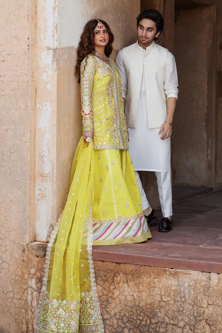 Model wearing yellow Dania SH - 05 dress from Qalamkar, featuring intricate embellishments and embroidery, perfect for Pakistani wedding clothes in the UK.