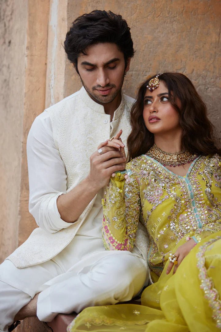 Model wearing yellow Dania SH - 05 dress from Qalamkar, featuring intricate embellishments and embroidery, perfect for Pakistani wedding clothes in the UK.