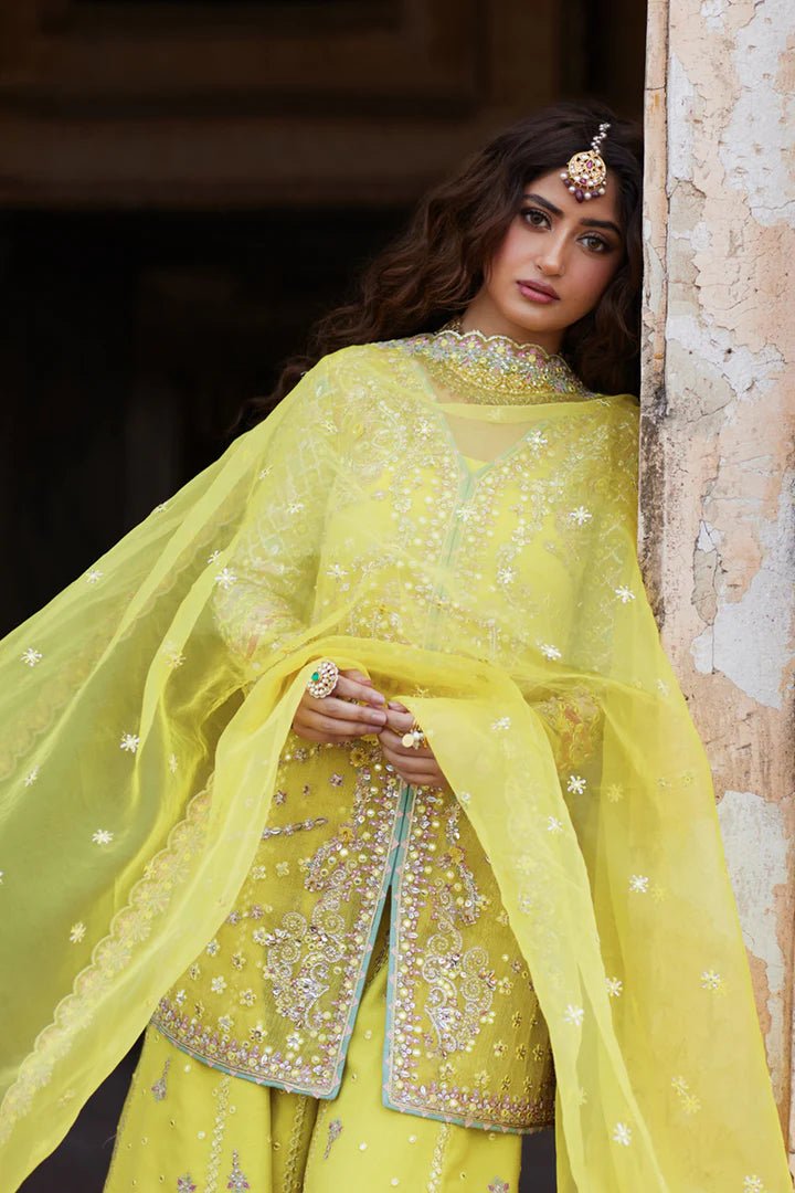 Model wearing yellow Dania SH - 05 dress from Qalamkar, featuring intricate embellishments and embroidery, perfect for Pakistani wedding clothes in the UK.