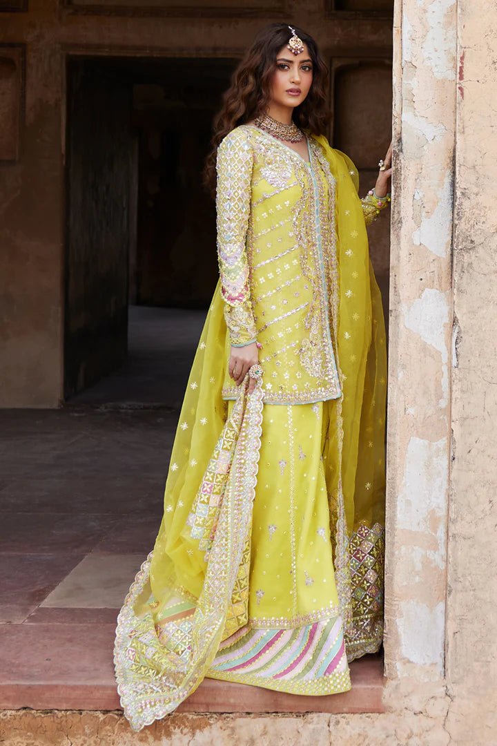 Model wearing yellow Dania SH - 05 dress from Qalamkar, featuring intricate embellishments and embroidery, perfect for Pakistani wedding clothes in the UK.