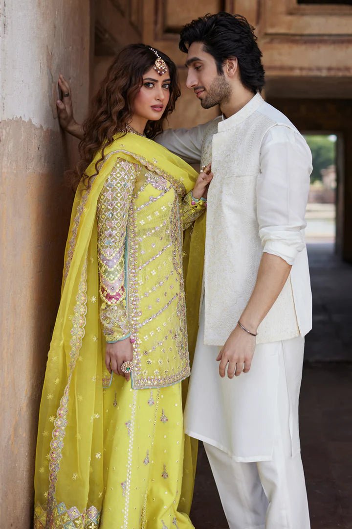 Model wearing yellow Dania SH - 05 dress from Qalamkar, featuring intricate embellishments and embroidery, perfect for Pakistani wedding clothes in the UK.