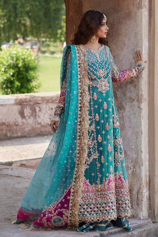 Model wearing Qalamkaar Shadmani Luxury Formals '24 Sama SH - 03 dress in teal with intricate gold embroidery. Shop Pakistani bridal dresses online in the UK now.