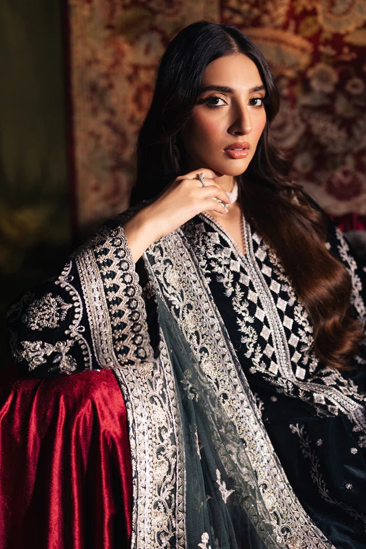 Model wearing Qalamkar Velvet Edit '24 BK - 03 SAMIRA, an elegant black velvet dress with intricate silver embroidery, ideal for weddings. Available as Pakistani clothes online in the UK.