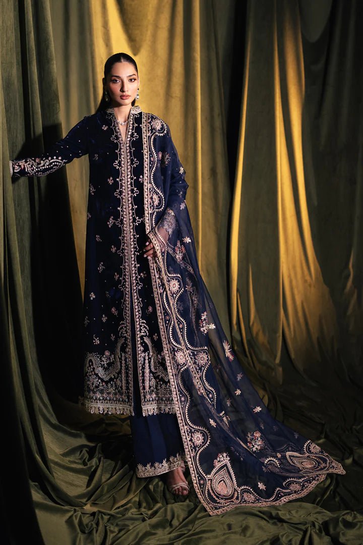 Model wearing Qalamkar Velvet Edit '24 BK - 05 DALIA, an elegant navy velvet dress with intricate embroidery, ideal for weddings. Available as Pakistani clothes online in the UK.