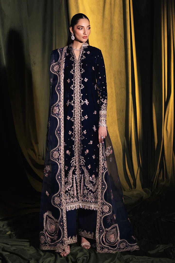 Model wearing Qalamkar Velvet Edit '24 BK - 05 DALIA, an elegant navy velvet dress with intricate embroidery, ideal for weddings. Available as Pakistani clothes online in the UK.