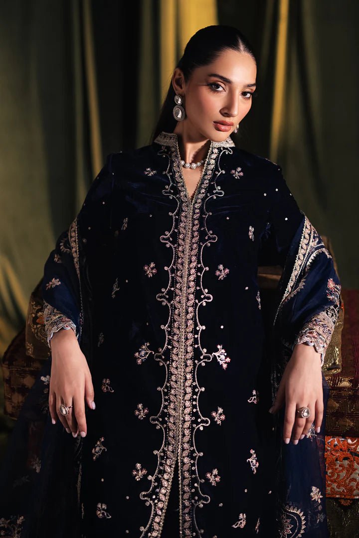 Model wearing Qalamkar Velvet Edit '24 BK - 05 DALIA, an elegant navy velvet dress with intricate embroidery, ideal for weddings. Available as Pakistani clothes online in the UK.