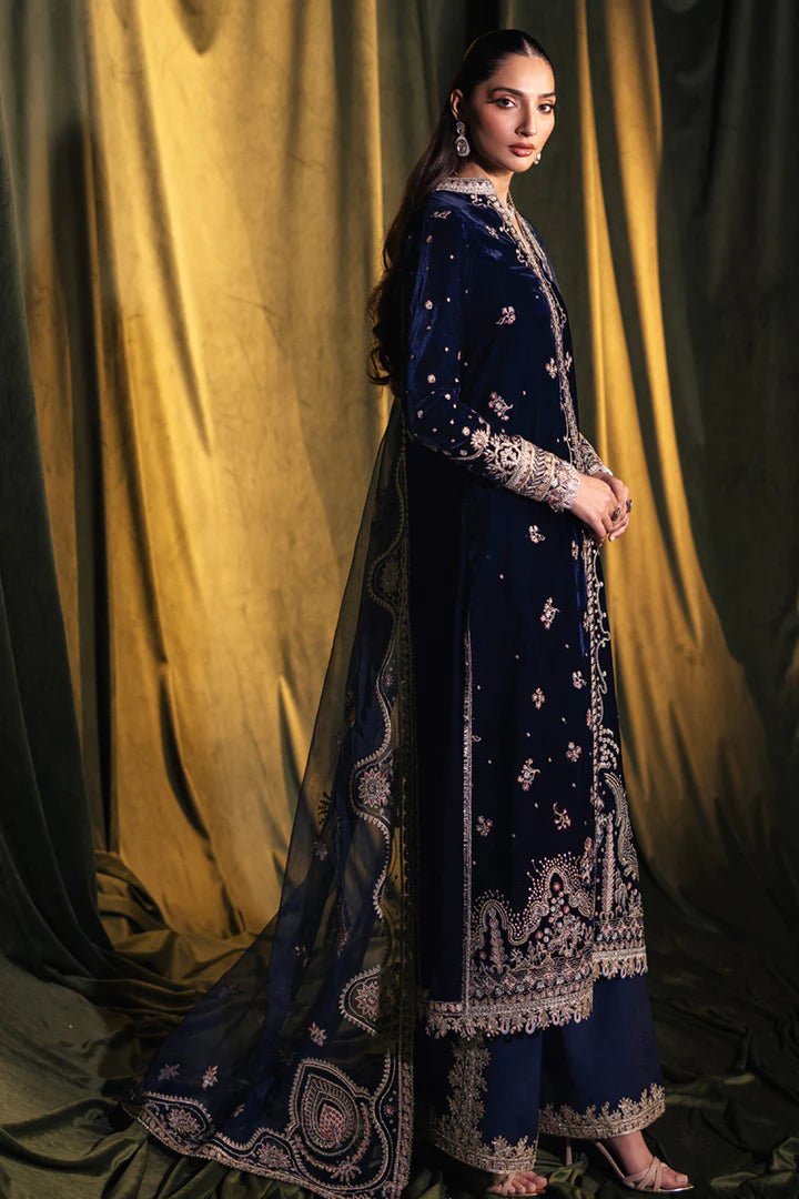 Model wearing Qalamkar Velvet Edit '24 BK - 05 DALIA, an elegant navy velvet dress with intricate embroidery, ideal for weddings. Available as Pakistani clothes online in the UK.