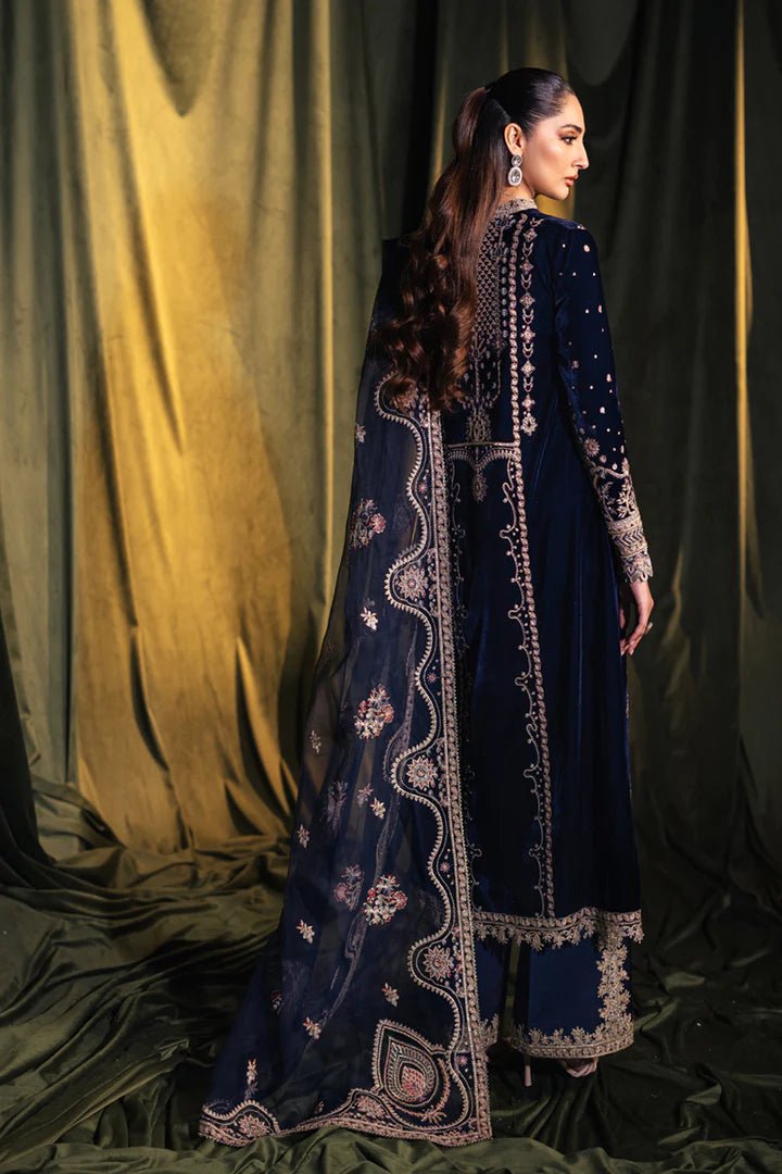 Model wearing Qalamkar Velvet Edit '24 BK - 05 DALIA, an elegant navy velvet dress with intricate embroidery, ideal for weddings. Available as Pakistani clothes online in the UK.