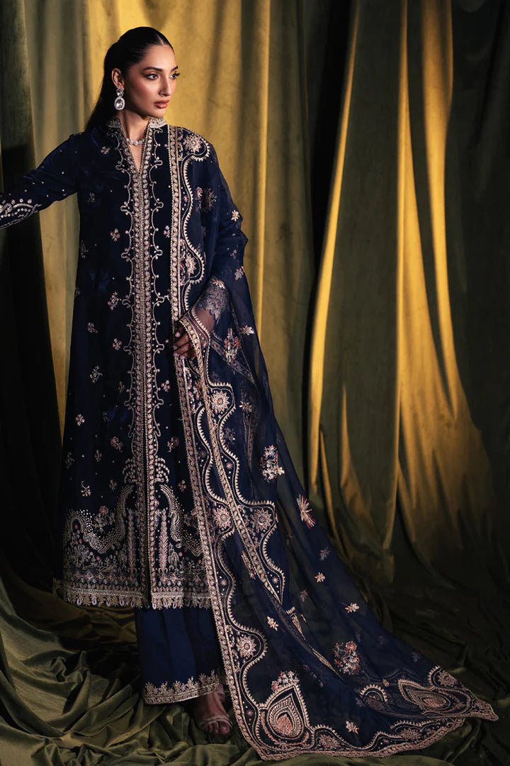 Model wearing Qalamkar Velvet Edit '24 BK - 05 DALIA, an elegant navy velvet dress with intricate embroidery, ideal for weddings. Available as Pakistani clothes online in the UK.