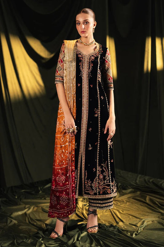 Model wearing Qalamkar Velvet Edit '24 BK - 06 ZOLA, a luxurious black velvet dress with intricate embroidery and vibrant dupatta, perfect for weddings. Available as Pakistani clothes online in the UK.