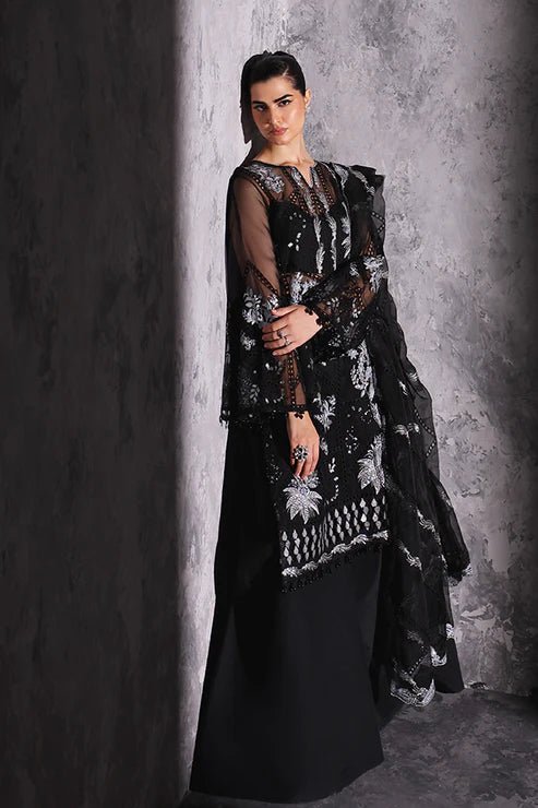 Model wearing Saffron Gul - e - Aftab dress in black from the Aatish Formals collection, featuring elegant white embroidery. Ideal for Pakistani wedding clothes online in the UK.