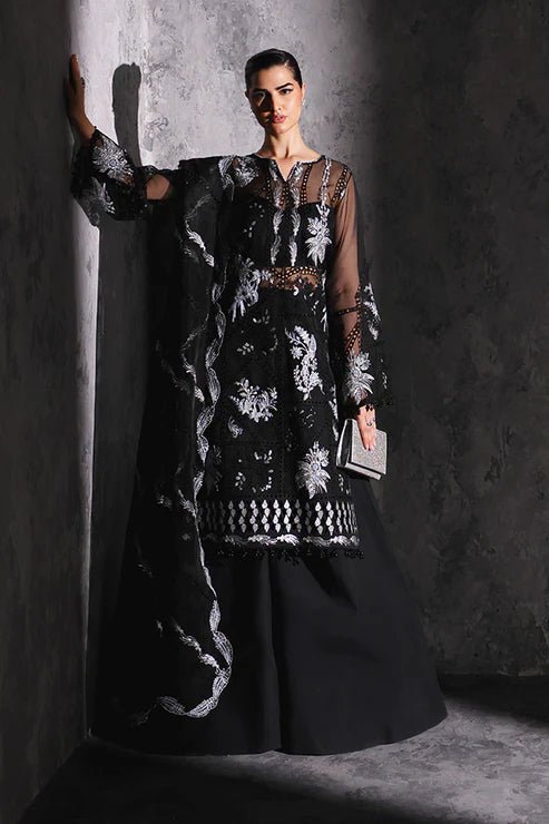 Model wearing Saffron Gul - e - Aftab dress in black from the Aatish Formals collection, featuring elegant white embroidery. Ideal for Pakistani wedding clothes online in the UK.