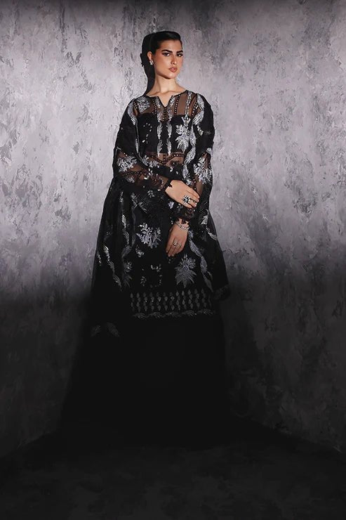 Model wearing Saffron Gul - e - Aftab dress in black from the Aatish Formals collection, featuring elegant white embroidery. Ideal for Pakistani wedding clothes online in the UK.