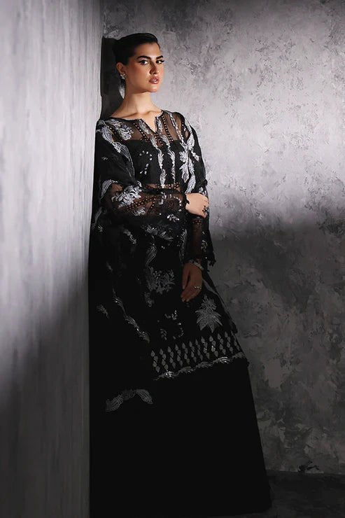 Model wearing Saffron Gul - e - Aftab dress in black from the Aatish Formals collection, featuring elegant white embroidery. Ideal for Pakistani wedding clothes online in the UK.