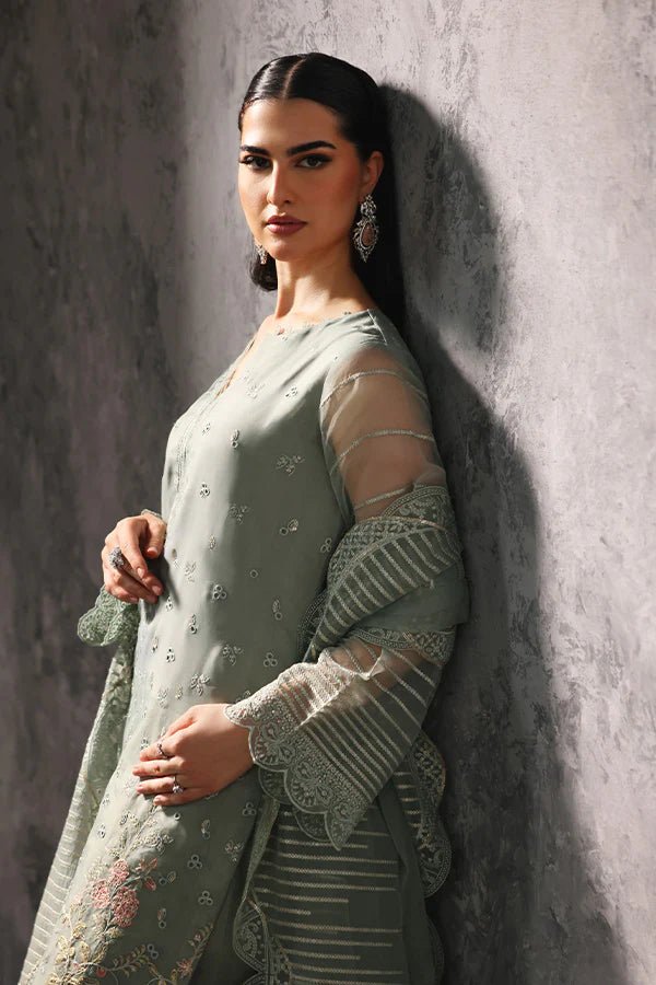 Model wearing Saffron Sehar - e - Shama dress in soft green from the Aatish Formals collection, available for Pakistani wedding clothes online in the UK.