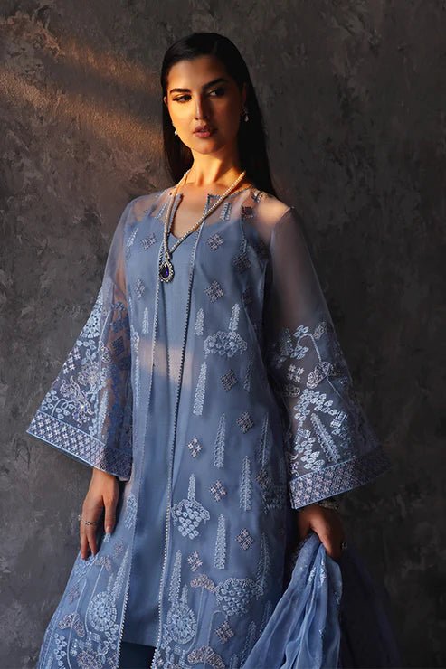 Model wearing Saffron Shama - e - Feroz dress in blue from the Aatish Formals collection, available for Pakistani wedding clothes online in the UK.