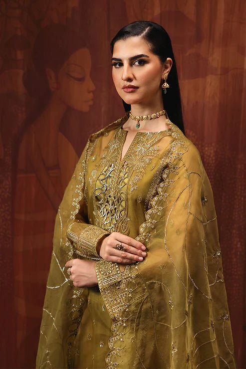 Model wearing Saffron Shola - e - Noor dress in mustard from the Aatish Formals collection, perfect for weddings, available for Pakistani clothes online in the UK.