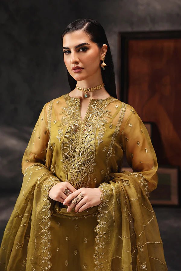 Model wearing Saffron Shola - e - Noor dress in mustard from the Aatish Formals collection, perfect for weddings, available for Pakistani clothes online in the UK.