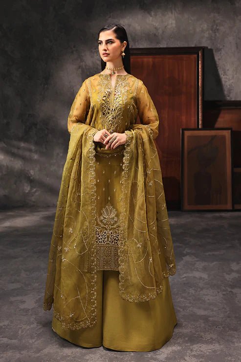 Model wearing Saffron Shola - e - Noor dress in mustard from the Aatish Formals collection, perfect for weddings, available for Pakistani clothes online in the UK.