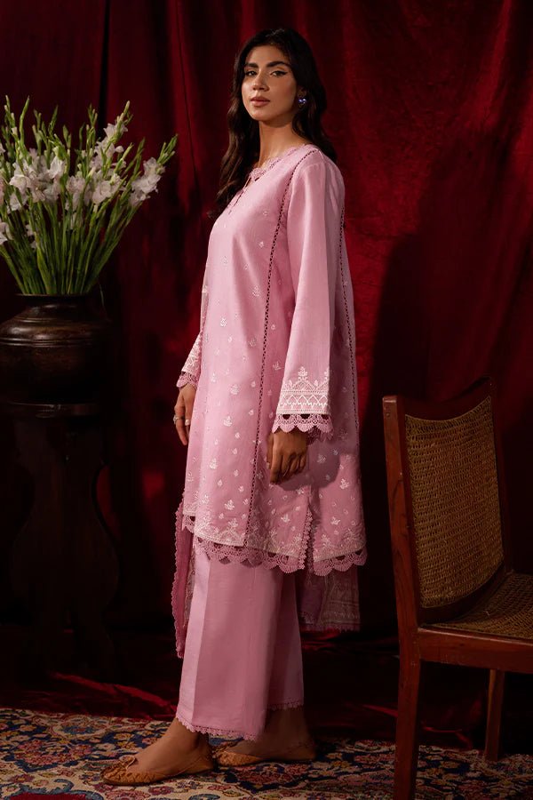 Model wearing a pink Blush Breeze dress from Saffron, featuring delicate embroidery, perfect for winter, showcasing Pakistani designer clothes online in the UK.