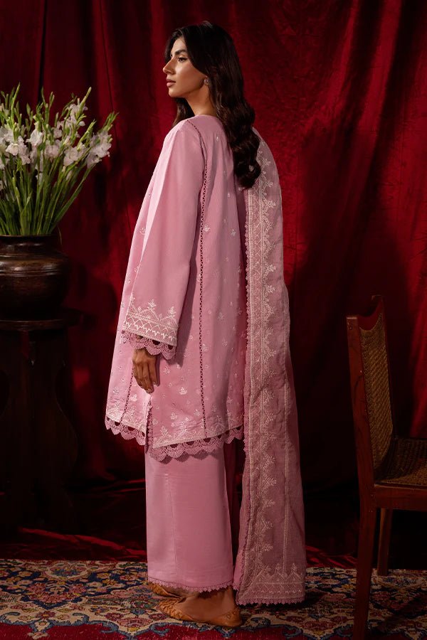 Model wearing a pink Blush Breeze dress from Saffron, featuring delicate embroidery, perfect for winter, showcasing Pakistani designer clothes online in the UK.