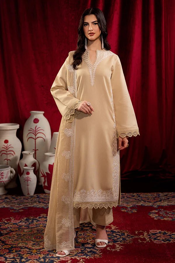 Model wearing Saffron Celestial Fall '24 FROSTED BEIGE, a graceful beige outfit with delicate embroidery, ideal for winter. Available as Pakistani designer clothes online in the UK.