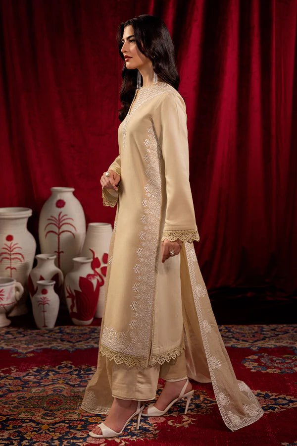 Model wearing Saffron Celestial Fall '24 FROSTED BEIGE, a graceful beige outfit with delicate embroidery, ideal for winter. Available as Pakistani designer clothes online in the UK.