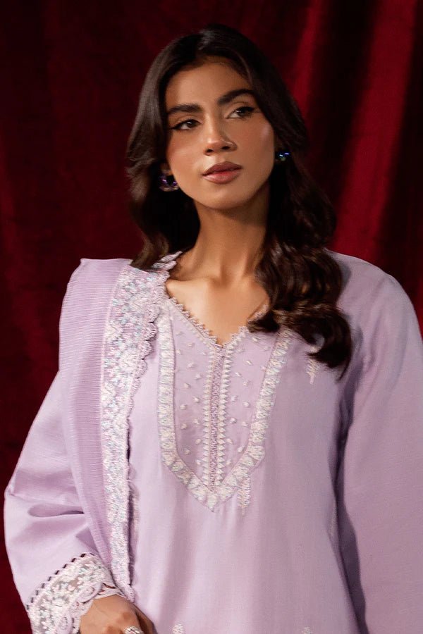 Model wearing Saffron Celestial Fall '24 LILY BLOOM, a pastel lilac outfit with delicate embroidery, ideal for winter. Available as Pakistani designer clothes online in the UK.