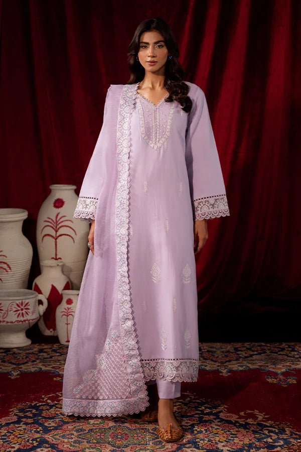 Model wearing Saffron Celestial Fall '24 LILY BLOOM, a pastel lilac outfit with delicate embroidery, ideal for winter. Available as Pakistani designer clothes online in the UK.