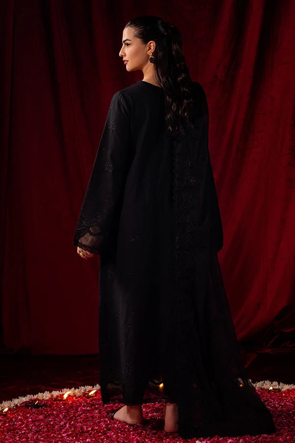 Model wearing Saffron Celestial Fall '24 MIDNIGHT ONYX, an elegant black outfit with intricate embroidery, perfect for winter. Available as Pakistani designer clothes online in the UK.