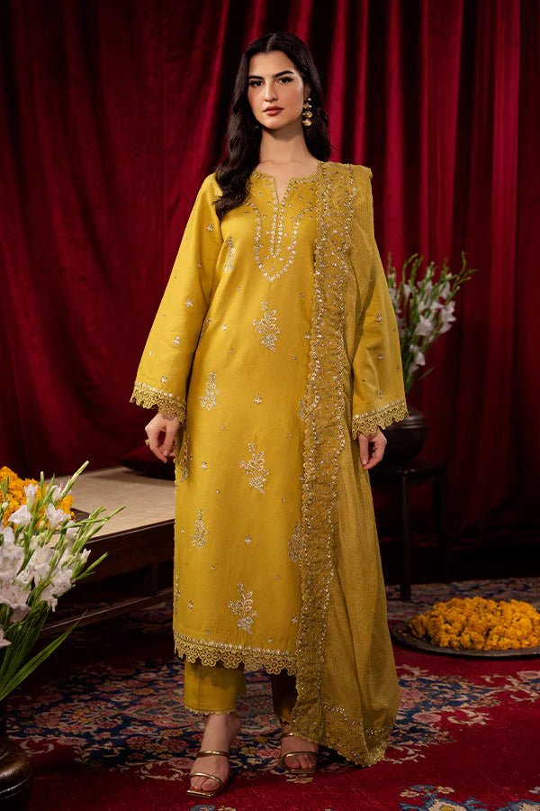 Model wearing a mustard yellow Tuscan Sunset dress from Saffron, detailed with embroidery, ideal for winter, showcasing Pakistani designer clothes online in the UK.