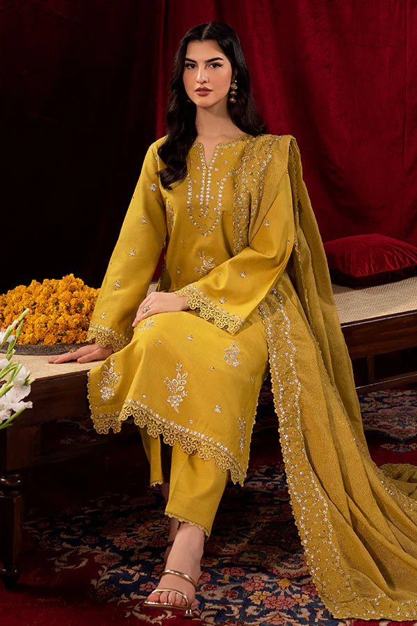 Model wearing a mustard yellow Tuscan Sunset dress from Saffron, detailed with embroidery, ideal for winter, showcasing Pakistani designer clothes online in the UK.