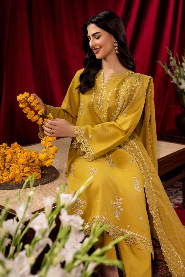 Model wearing a mustard yellow Tuscan Sunset dress from Saffron, detailed with embroidery, ideal for winter, showcasing Pakistani designer clothes online in the UK.