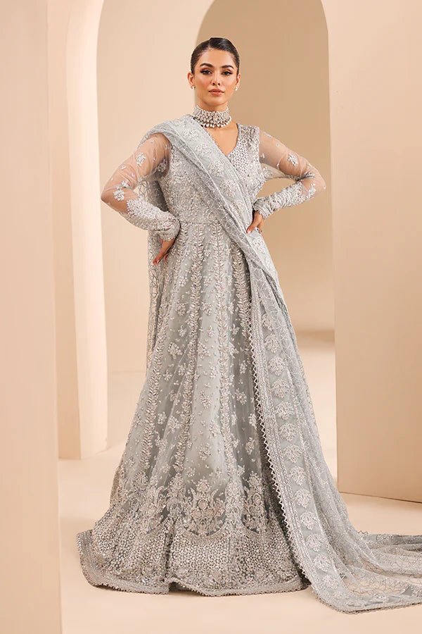 Model wearing 04 Silver Whisper from Saffron's Edel Formals Collection in elegant silver tones. Pakistani clothes online in UK at Signature Labels