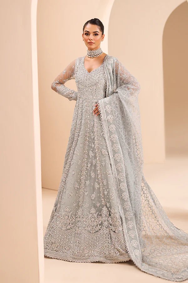 Model wearing 04 Silver Whisper from Saffron's Edel Formals Collection in elegant silver tones. Pakistani clothes online in UK at Signature Labels