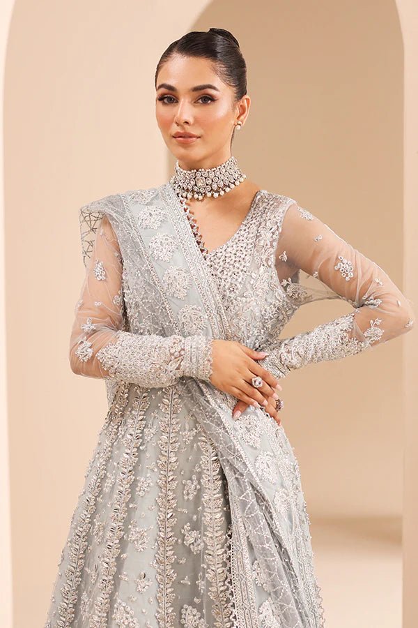 Model wearing 04 Silver Whisper from Saffron's Edel Formals Collection in elegant silver tones. Pakistani clothes online in UK at Signature Labels