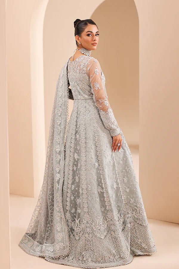 Model wearing 04 Silver Whisper from Saffron's Edel Formals Collection in elegant silver tones. Pakistani clothes online in UK at Signature Labels