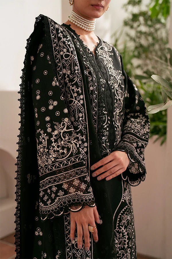 Model wearing black Ebony dress from Saffron, featuring intricate embroidery. Ideal for Pakistani designer clothes in the UK, readymade clothes, and festive lawn collections.