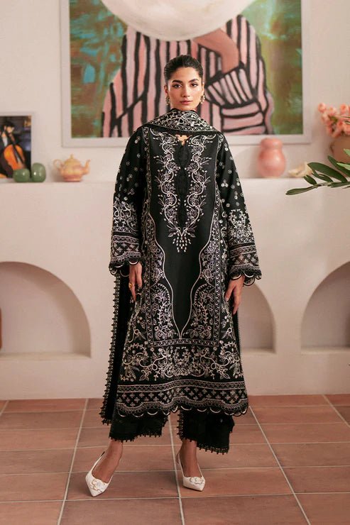 Model wearing black Ebony dress from Saffron, featuring intricate embroidery. Ideal for Pakistani designer clothes in the UK, readymade clothes, and festive lawn collections.